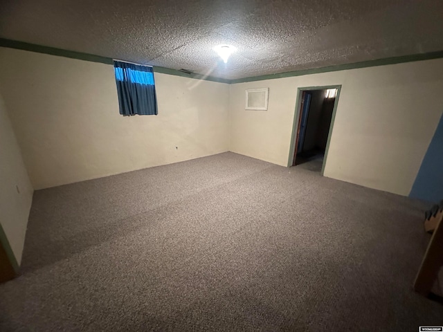 basement featuring a textured ceiling and carpet