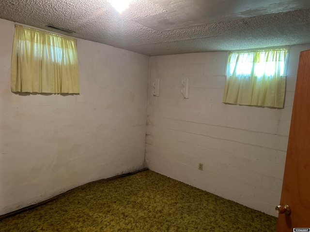 unfurnished room featuring a textured ceiling