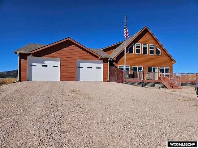 view of front of house featuring a garage and a deck