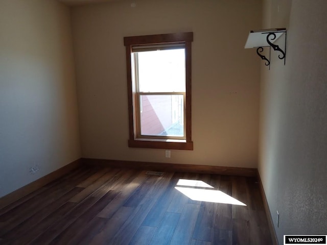 empty room featuring dark wood-type flooring