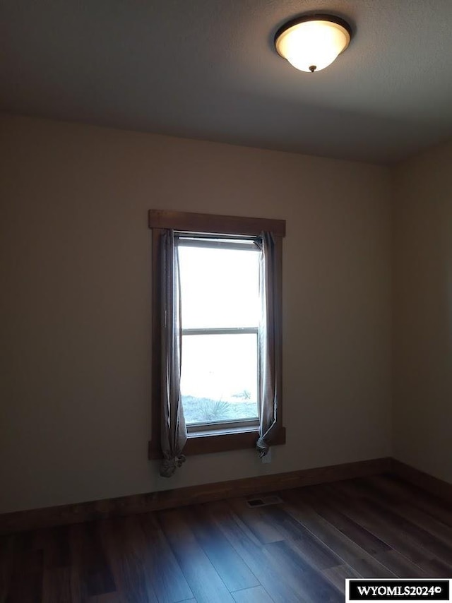 empty room with hardwood / wood-style floors