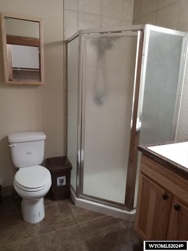 bathroom with vanity, toilet, and walk in shower