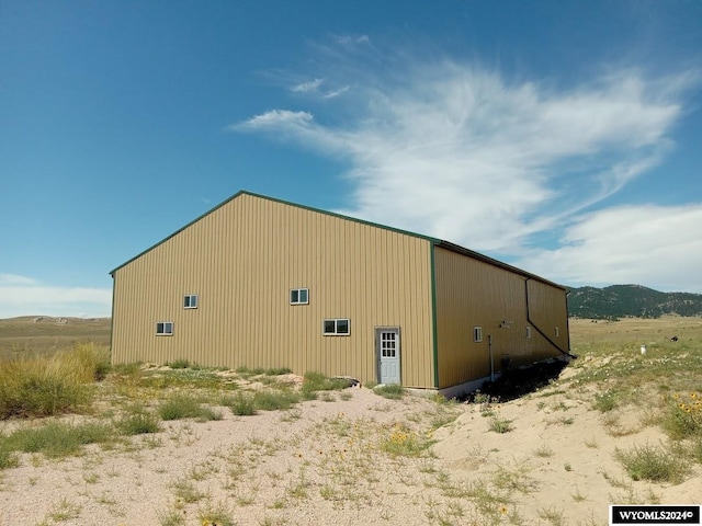 exterior space with a mountain view and an outdoor structure