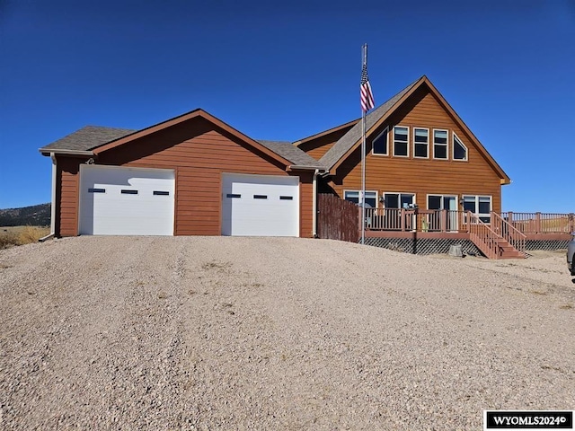 view of front of home with a garage and a wooden deck