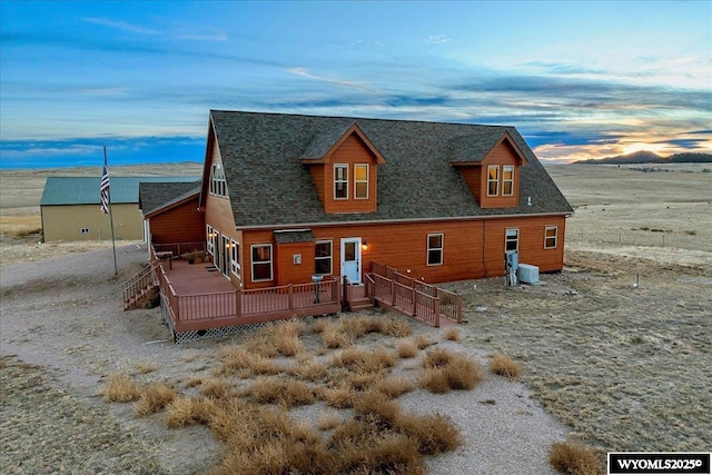 view of front of property featuring a wooden deck and cooling unit