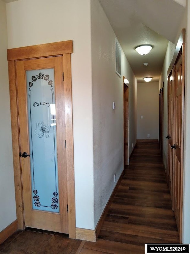 hallway with dark wood-type flooring