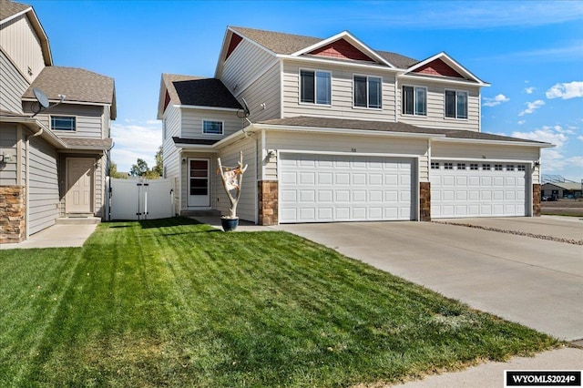 view of front of property with a garage and a front lawn