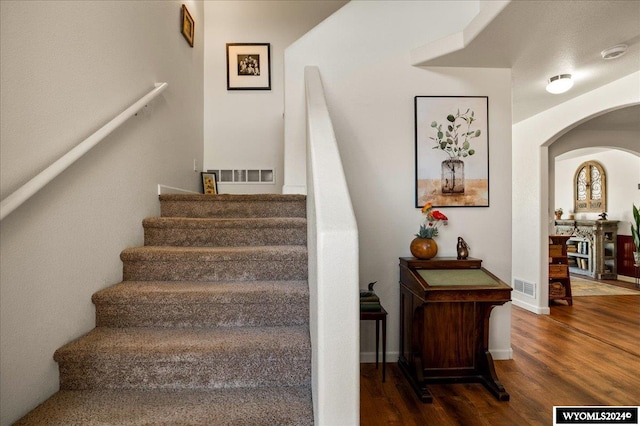 stairway featuring hardwood / wood-style flooring