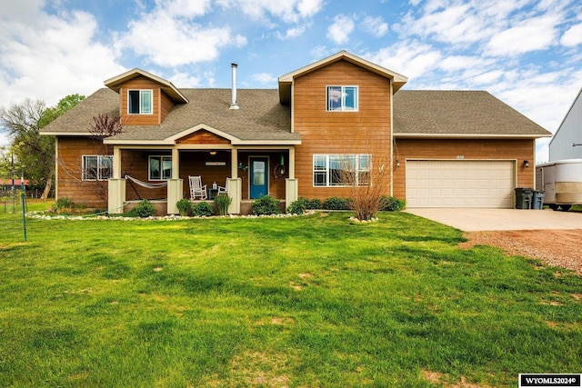 view of front of house with covered porch, a front yard, and a garage