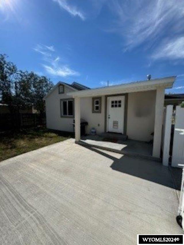 207 W Walnut Sts, Lyman, WY 82937 - single story home featuring fence, stucco siding, and a patio