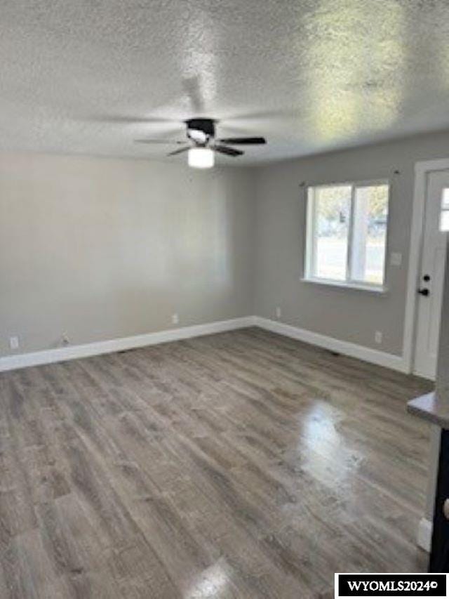 interior space featuring a textured ceiling, hardwood / wood-style flooring, and ceiling fan