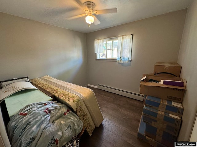 bedroom with dark hardwood / wood-style floors, ceiling fan, and a baseboard radiator