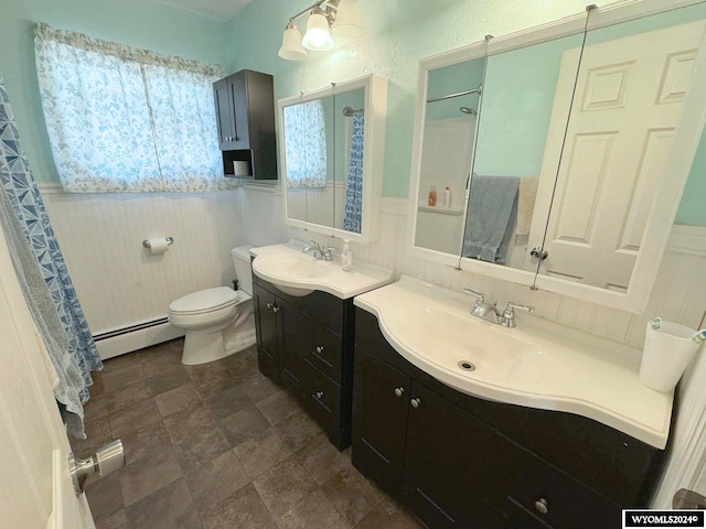 bathroom featuring vanity, toilet, a baseboard heating unit, and a shower with shower curtain