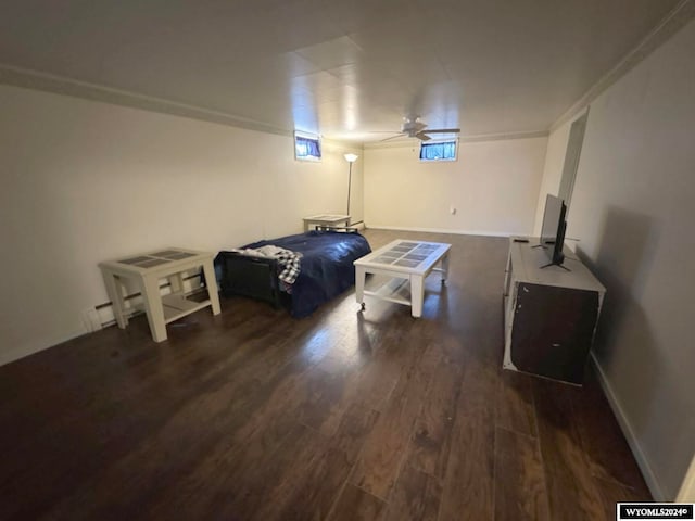 bedroom with ornamental molding and dark wood-type flooring