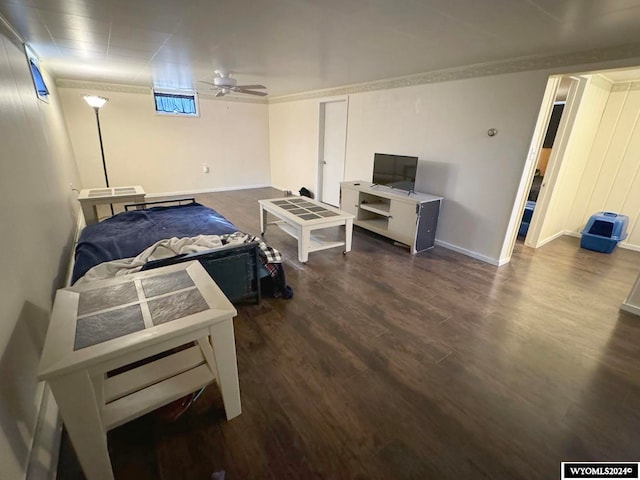 bedroom featuring crown molding, dark hardwood / wood-style floors, and ceiling fan