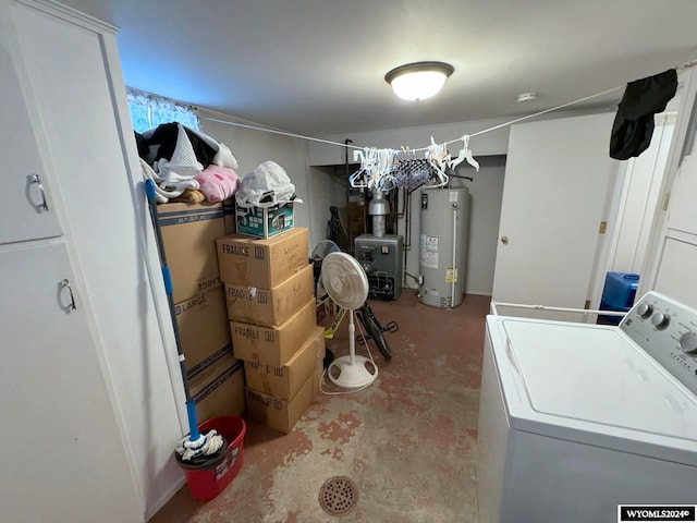 laundry area with gas water heater and washer / dryer