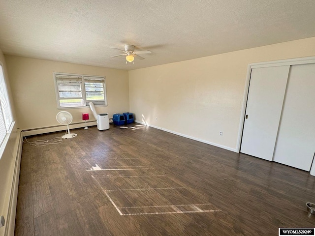 interior space with ceiling fan, a textured ceiling, a closet, dark hardwood / wood-style floors, and a baseboard radiator