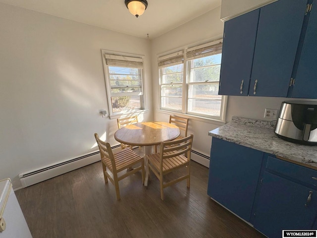 dining area featuring a baseboard heating unit, dark hardwood / wood-style floors, and a healthy amount of sunlight