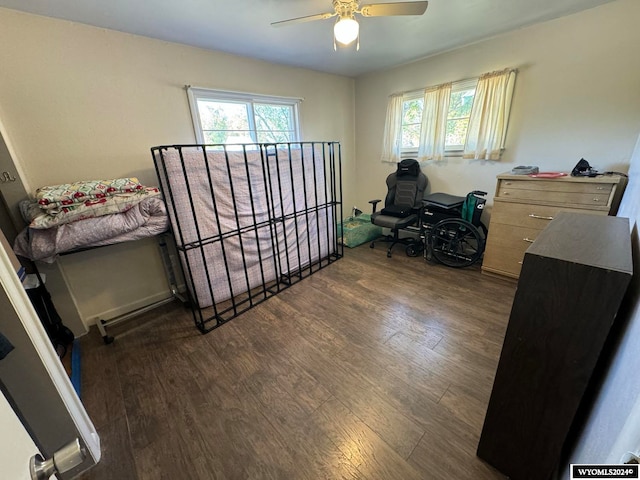 bedroom with ceiling fan and dark wood-type flooring