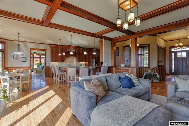 living room featuring light wood-type flooring, beamed ceiling, coffered ceiling, and crown molding