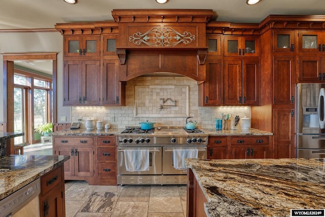 kitchen with decorative backsplash, light stone countertops, and stainless steel appliances