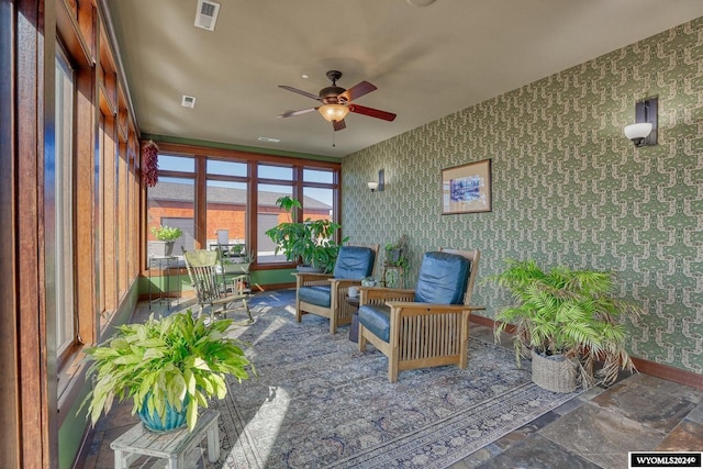 sunroom featuring ceiling fan