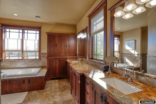 bathroom featuring vanity and a bath