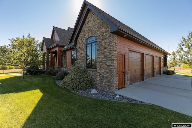 view of side of home with a garage and a yard