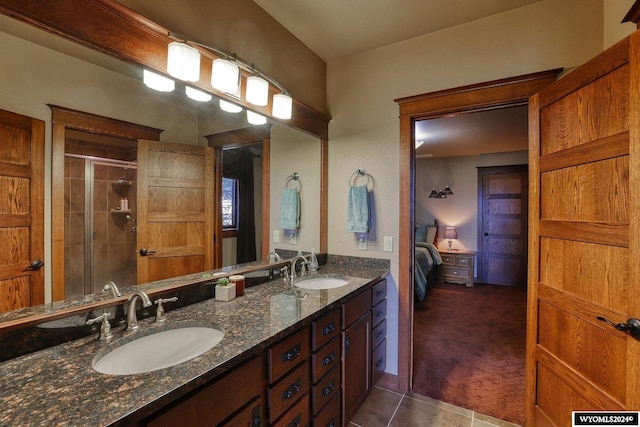 bathroom featuring vanity, a shower with door, and tile patterned floors