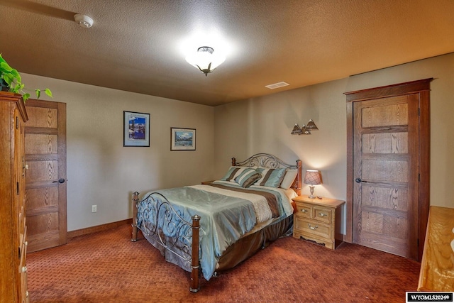 carpeted bedroom featuring a textured ceiling