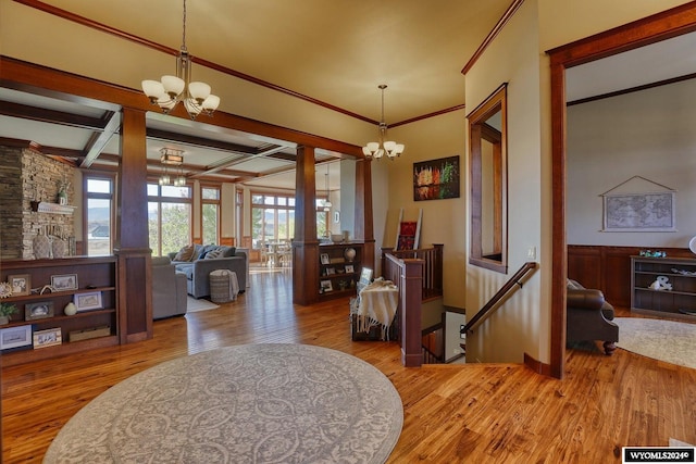 entrance foyer featuring light hardwood / wood-style floors, an inviting chandelier, and beamed ceiling