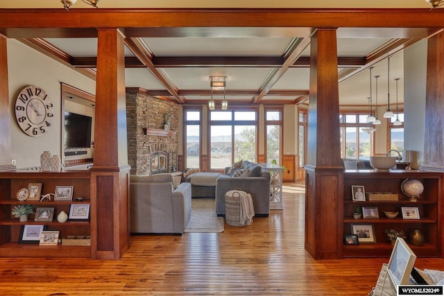 living room featuring beamed ceiling, coffered ceiling, a fireplace, and hardwood / wood-style floors