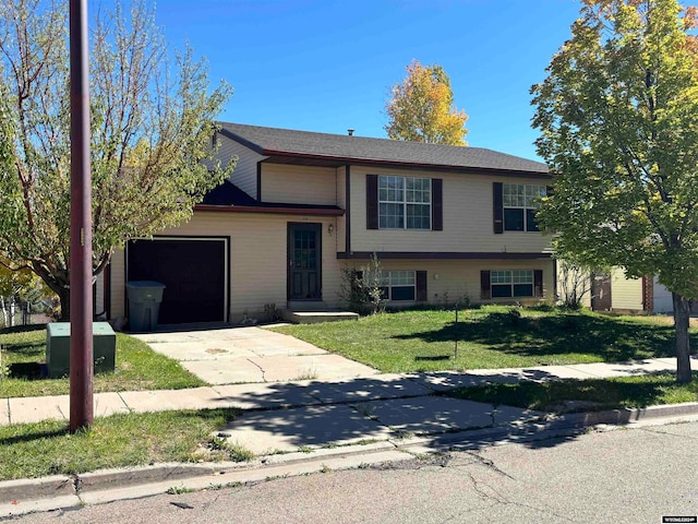 view of front of property with a front lawn and a garage