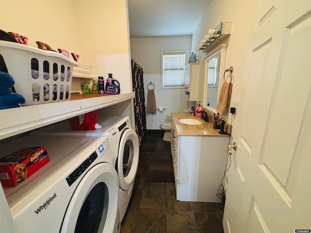 laundry area featuring washer and clothes dryer and sink