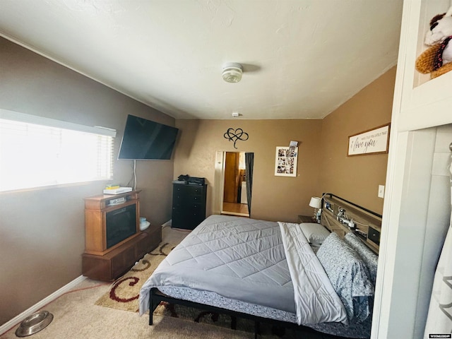 carpeted bedroom featuring vaulted ceiling