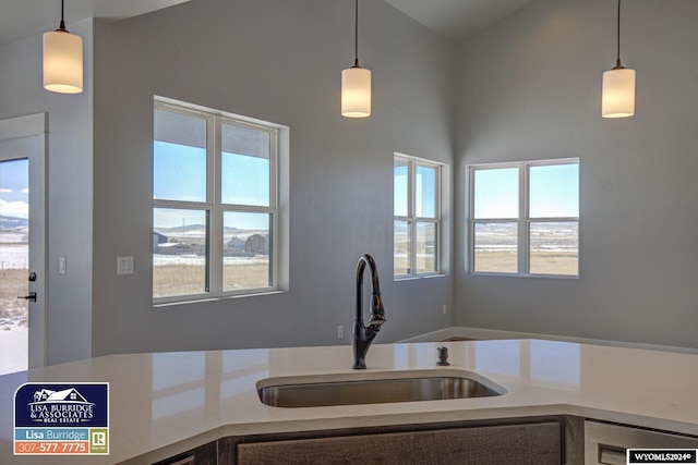 kitchen with dishwasher, hanging light fixtures, and sink