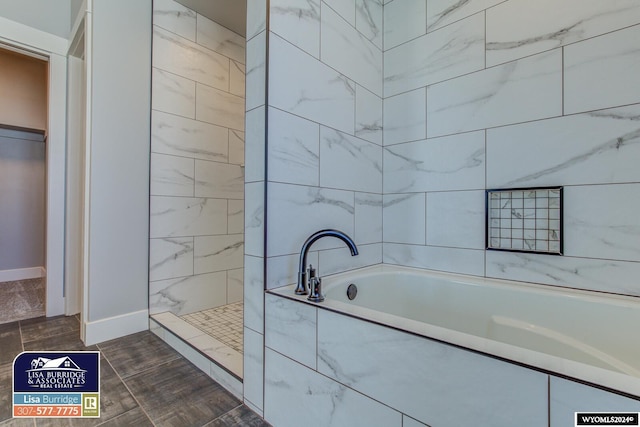 bathroom featuring hardwood / wood-style floors and separate shower and tub