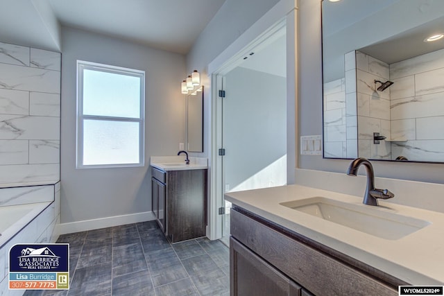 bathroom with tiled shower / bath combo and vanity