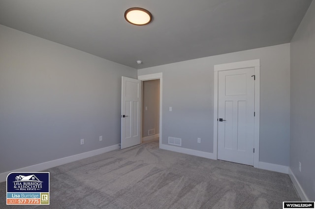 unfurnished bedroom featuring light colored carpet