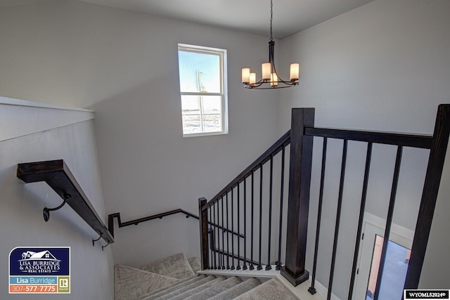 stairs featuring a notable chandelier