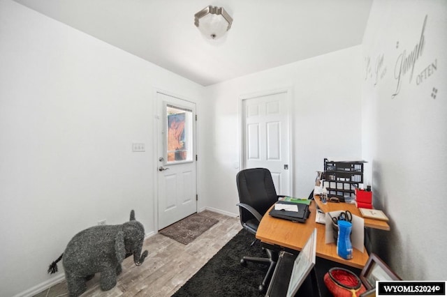 home office with light hardwood / wood-style floors