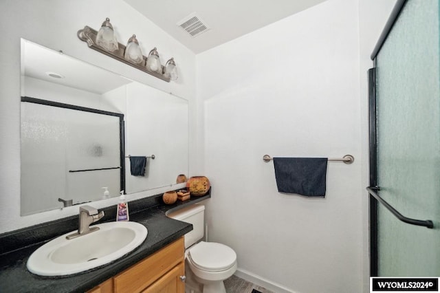 bathroom featuring walk in shower, vanity, hardwood / wood-style floors, and toilet