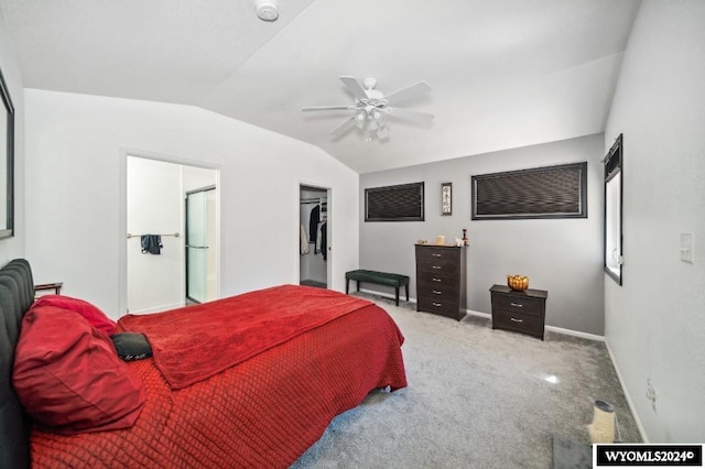 bedroom with a closet, vaulted ceiling, light carpet, a spacious closet, and ceiling fan