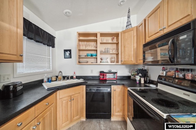 kitchen featuring black appliances, lofted ceiling, sink, and light hardwood / wood-style flooring