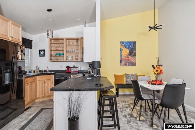 kitchen featuring vaulted ceiling, a breakfast bar, kitchen peninsula, black appliances, and sink