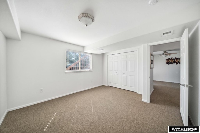 unfurnished bedroom with a closet and carpet flooring