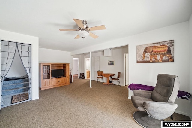 sitting room featuring ceiling fan and carpet floors