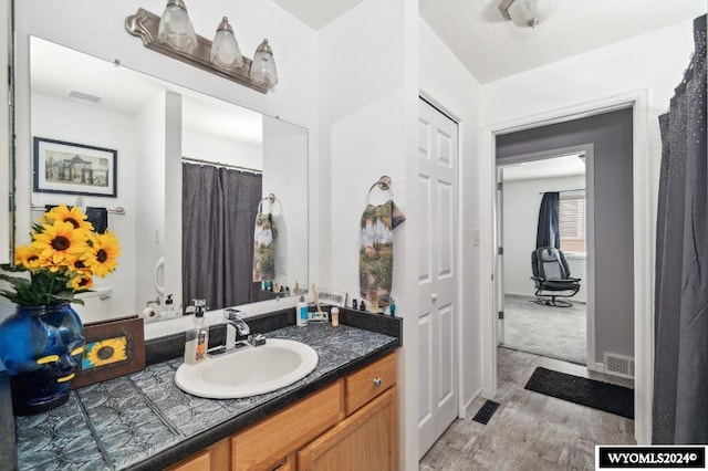 bathroom featuring vanity and hardwood / wood-style flooring