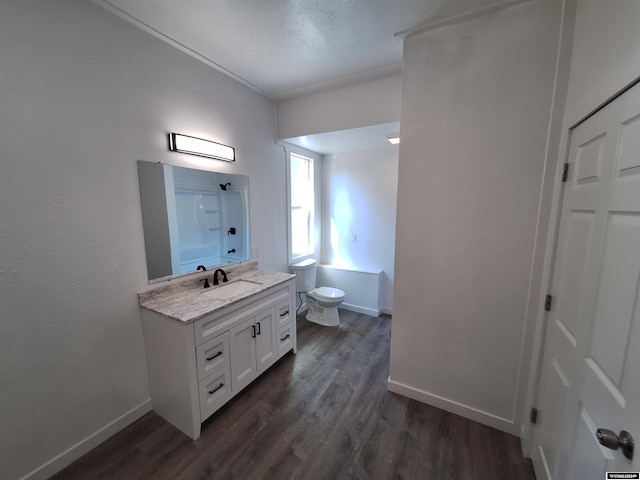 full bathroom with hardwood / wood-style flooring, shower / bath combination, toilet, and vanity