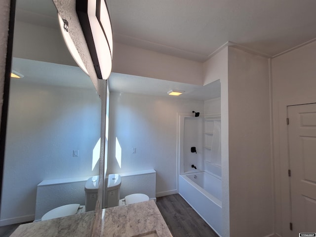 bathroom featuring shower / bathtub combination, hardwood / wood-style floors, and vanity